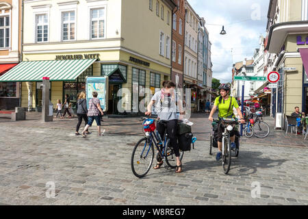 Germany Rostock, Two women on bicycles in the city center People tourists cycling Stock Photo