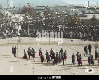 [ 1900s Japan - Japanese School Life ] —   Elementary school girls participate in their school's sports day.  This image is part of 'The School Life of Young Japan' (No 18), a series published by Japanese photographer Kozaburo Tamamura in the early 1900s (late Meiji).  20th century vintage glass slide. Stock Photo