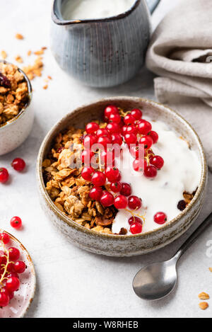 Greek yogurt with oat granola and red berries. Clean eating, dieting, weight loss concept Stock Photo