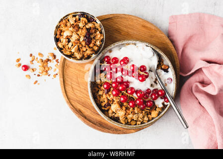 Oat granola with yogurt, berries in bowl. Top view. Healthy food concept Stock Photo