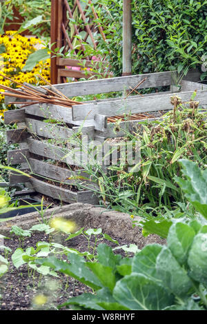 Wooden composter, compost heap in allotment garden bin Stock Photo