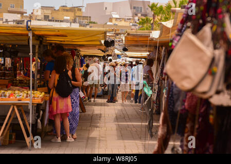 MARSAXLOKK, MALTA -5 may,2019: Tourist in Traditional street food market in Marsaxlokk which is holding every day. Sunday market.Marsaxlokk Malta Euro Stock Photo