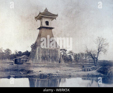[ 1890s Japan - Sumiyoshi Lighthouse, Osaka ] —   Sumiyoshi Taka-doro lighthouse in Sumiyoshi-ura, Osaka. The tower was destroyed by typhoon Jane in 1950 (Showa 25) and rebuilt in stone.   The lighthouse, which burnt rapeseed oil, was made as an offering to the guardian deity of Sumiyoshi Shrine at the end of the Kamakura period (1185–1333), making it Japan’s oldest lighthouse.  19th century vintage albumen photograph. Stock Photo
