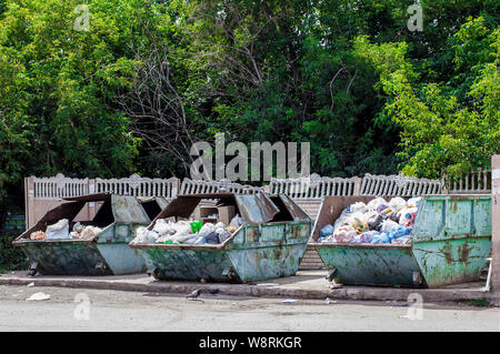 Full trash bins in a city. Garbage cans in a town Stock Photo