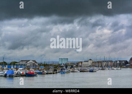 Dark stormy rain and storm clouds overhead over a river in the UK. Stock Photo