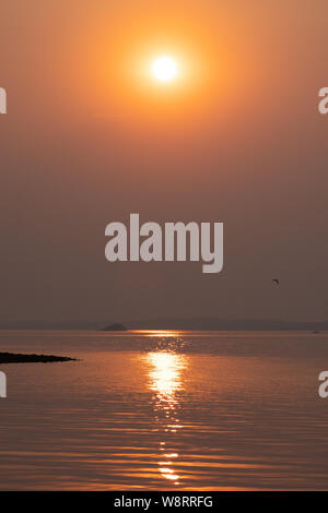 Red African Sun setting over Lake Kariba, Zimbabwe Stock Photo