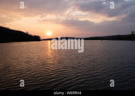 Red African Sun setting over Lake Kariba, Zimbabwe Stock Photo