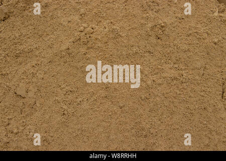 Yellow sand texture background close-up. Construction sand, sandstone, a lot of yellow sand, texture is clearly visible. Beige sand granules Stock Photo