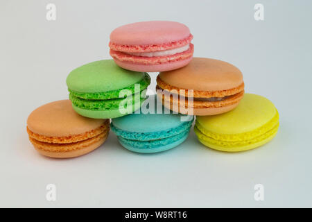 Colorful macaroni cakes on white background. Sweets many colors pink, orange, yellow, blue. Baking, cookies, cute. Macaruni of all colors standing pyr Stock Photo