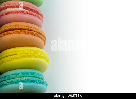 Colorful macaroni cakes on white background. Sweets many colors pink, orange, yellow, blue. Baking cookies cute free copy space Stock Photo