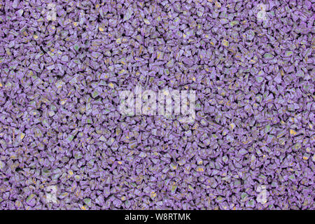 Lilac violet rubber coating for children playground. Texture granular background. Outdoor floor covering for sports fitness games, soft rubber granule Stock Photo