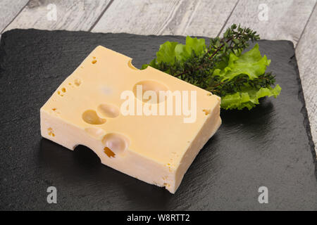 Maasdam cheese brick with thyme branch Stock Photo