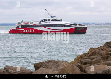 Red Jet ferry, Red Jet 6 ferry, high speed catamaran approaching West Cowes, Isle of Wight from Southampton, Hampshire, UK in August Stock Photo