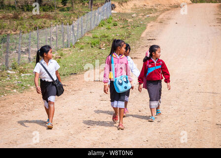 Vang Vieng, Laos - Feb 2016: Kids walking home from school in Laotian countryside Stock Photo