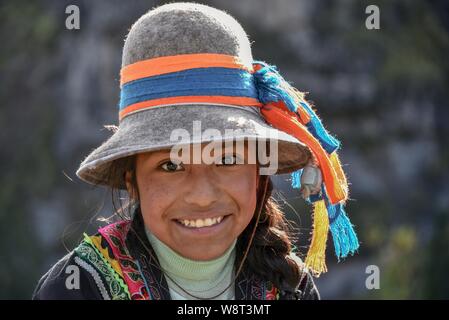 Indio girl with hat smiles, portrait, at Cusco, Peru Stock Photo