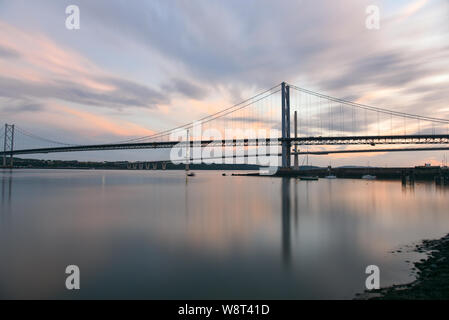View of Forth Road Bridge and Queensferry Crossing motorway bridge across the Firth of Forth at dusk Stock Photo