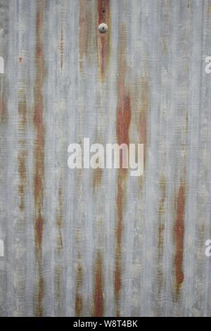 Rusty zinc metal sheet, Corrugated zinc tile pattern, wall materials. Old barn house. Stock Photo
