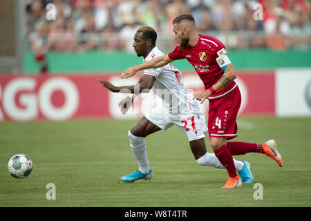 Halberstadt, Germany. 11th Aug, 2019. Soccer: DFB Cup, Germania Halberstadt - 1st FC Union Berlin, 1st round in Friedensstadion. Berlin's Sheraldo Becker (l) plays against Halberstadt's Tino Schulze. Credit: Swen Pförtner/dpa - IMPORTANT NOTE: In accordance with the requirements of the DFL Deutsche Fußball Liga or the DFB Deutscher Fußball-Bund, it is prohibited to use or have used photographs taken in the stadium and/or the match in the form of sequence images and/or video-like photo sequences./dpa/Alamy Live News Stock Photo