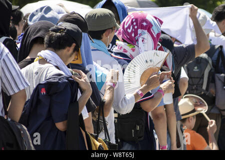 Tokyo, Japan. 11th Aug, 2019. Visitors line up to enter to the Comic Market (Comiket) 96 event in Tokyo Big Sight. Many manga fans and cosplayers lined up despite to the hot weather in Tokyo, which temperature reached 35.5 degrees Celsius, in the second day of the Comiket. The Comic Market was established in 1975 and focuses on manga, anime, gaming and cosplay. Organizers expect more than 200,000 visitors per day to attend the event which runs for fourth days until August 12. Credit: Rodrigo Reyes Marin/ZUMA Wire/Alamy Live News Stock Photo