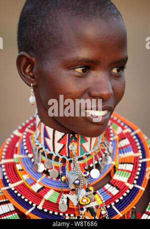 Young beautiful Maasai woman with traditional necklace poses for a portrait in Loitoktok, Kenya. Stock Photo
