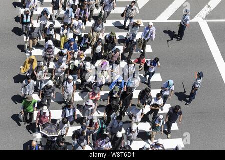 Tokyo, Japan. 11th Aug, 2019. Visitors line up to enter to the Comic Market (Comiket) 96 event in Tokyo Big Sight. Many manga fans and cosplayers lined up despite to the hot weather in Tokyo, which temperature reached 35.5 degrees Celsius, in the second day of the Comiket. The Comic Market was established in 1975 and focuses on manga, anime, gaming and cosplay. Organizers expect more than 200,000 visitors per day to attend the event which runs for fourth days until August 12. Credit: Rodrigo Reyes Marin/ZUMA Wire/Alamy Live News Stock Photo