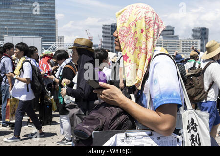 Tokyo, Japan. 11th Aug, 2019. Visitors gather at the Comic Market (Comiket) 96 event in Tokyo Big Sight. Many manga fans and cosplayers lined up despite to the hot weather in Tokyo, which temperature reached 35.5 degrees Celsius, in the second day of the Comiket. The Comic Market was established in 1975 and focuses on manga, anime, gaming and cosplay. Organizers expect more than 200,000 visitors per day to attend the event which runs for fourth days until August 12. Credit: Rodrigo Reyes Marin/ZUMA Wire/Alamy Live News Stock Photo