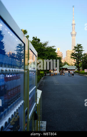 Tokyo / Japan - 31st July 2019: Asakusa district. Vending machines on the streets with the Tokyo Skytree in the background. Stock Photo