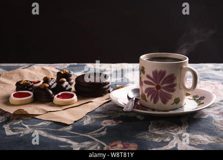 Cup of coffee with some chocolate pastries Stock Photo