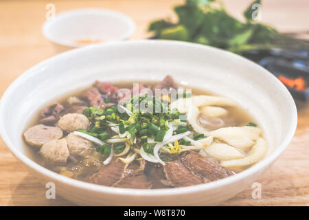 Special Beef vietnamese pho with soup and beef slices, brisket, beef balls, fish maw, scallions served with herbs Stock Photo