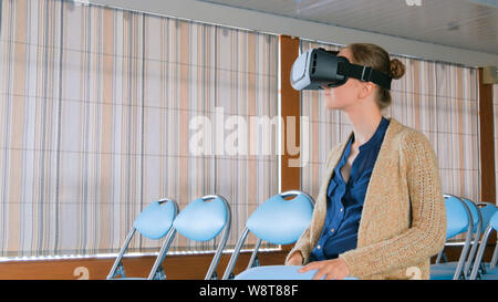 Young woman using virtual reality glasses Stock Photo