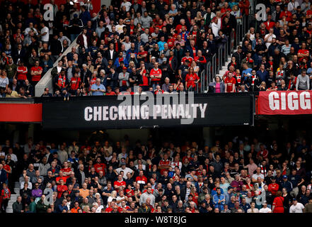 VAR (Video Assistant Referee) display to the fans on a scoreboard about checking a decision of a penalty during the Premier League match at Old Trafford, Manchester. Stock Photo
