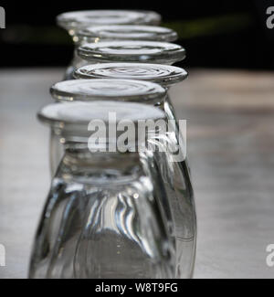 close up row of glasses turned upside down on a table Stock Photo