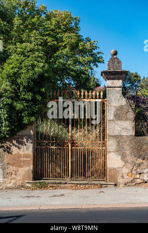 Antique very large wrought iron gates on French house drive Stock Photo