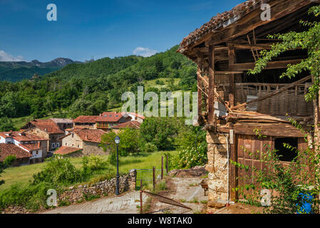 Barn in village of Mogrovejo in Liebana valley, Puertos de Salvoron in distance, at Picos de Europa, Cantabria, Spain Stock Photo