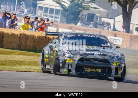 2017 Nissan GT-R 7.4 litre V8 with driver Steve Biagioni drifting on the hillclimb at the 2019 Goodwood Festival of Speed, Sussex, UK. Stock Photo