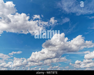 Cumulus clouds against a vibrant blue summers sky Stock Photo