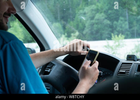 Man using smartphone while driving the car - transportation and vehicle concept with icon social media send email wifi chat read email Stock Photo