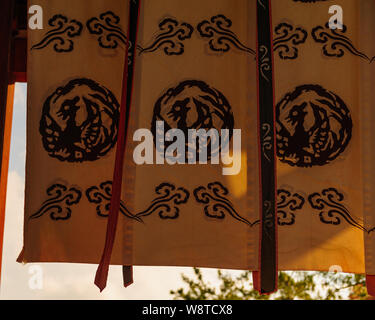 Wind hitted traditional fabric flags devorated with artful japanese emblems captured in a close up image, Nara Japan November 2018 Stock Photo