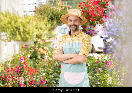 Contemporary farmer in workwear crossing arms on chest Stock Photo