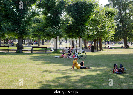 Copenhagen Park; people relaxing on a sunny summers day in August in Kongens Have ( The Kings garden ), Copenhagen city centre, Copenhagen Denmark Stock Photo