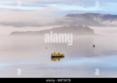 Small boat in mist and fog on Loch Carron, Wester Ross, Highlands of Scotland