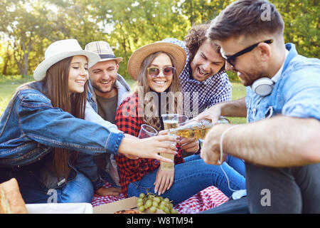 A group of young people having on a picnic in the park. Stock Photo