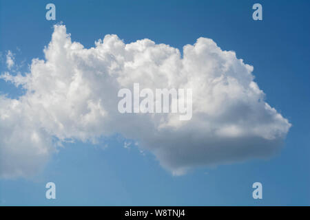 White cloud on blue sky. Closeup of a white cloud in a blue sky. The concept of cloud technologies. Stock Photo