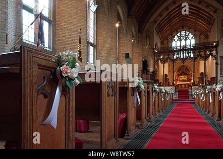 A parish church in the UK decorated in preparation for a wedding Stock Photo