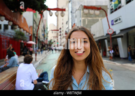 Portrait of beautiful smiling woman in Sao Paulo japanese neighborhood Liberdade, Sao Paulo, Brazil Stock Photo