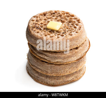 Stack  of wholemeal crumpets isolated on white background Stock Photo