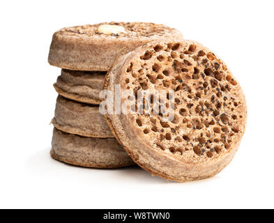 Stack  of wholemeal crumpets isolated on white background Stock Photo