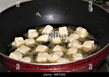 paneer or cottage cheese being fried in vegetable oil Stock Photo