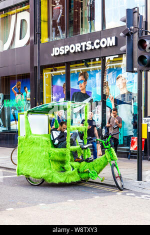 A rickshaw covered with green fur near Oxford Street in London, UK Stock Photo