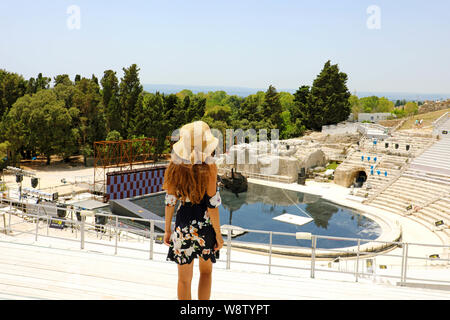 Portrait of young woman with hat in Syracuse (Siracusa) Greek theatre, Sicily, Italy Stock Photo